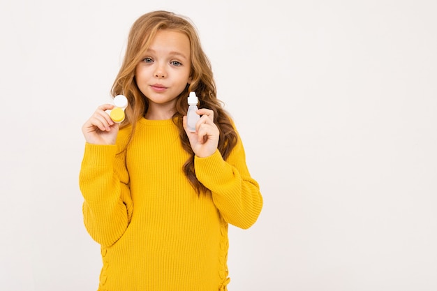 Portrait of little girl holding beauty products