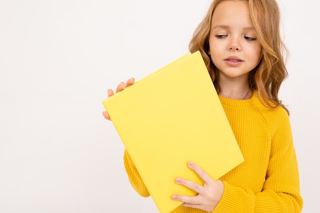 Portrait of little girl holding a blank paper