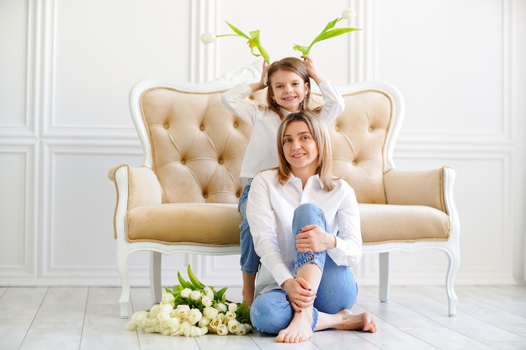 Photo portrait of little girl and loving mother with tulips