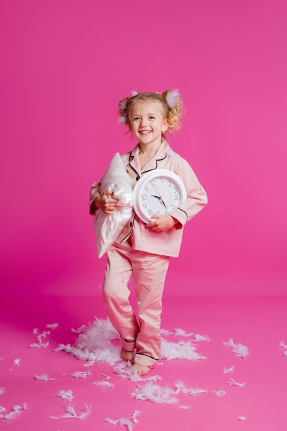 Portrait of a little girl in a pink pajama