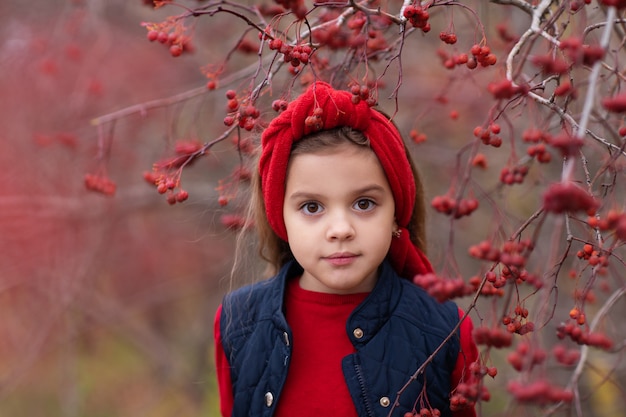 Portrait of a little girl in a Rowan tree