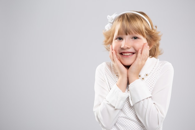 Portrait of a little girl she is happy and put her hands on her cheeks