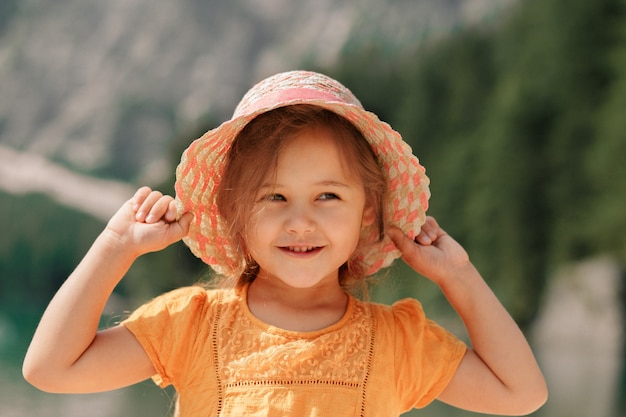 portrait of a little girl in a straw hat