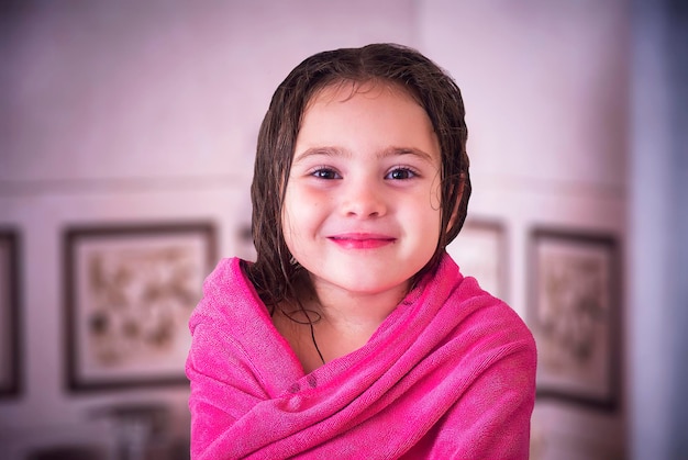 Portrait of little girl wearing towel after taking a shower. Childhood cleanliness bathing