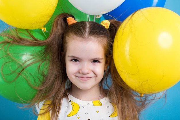 Portrait of little girl with balloons