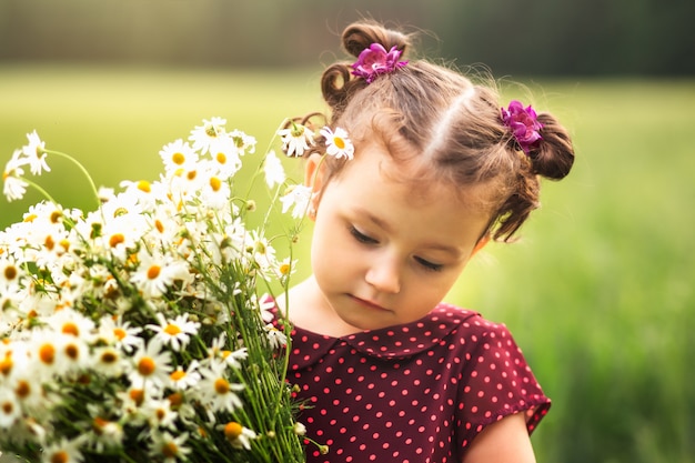 portrait of a little girl with daisies