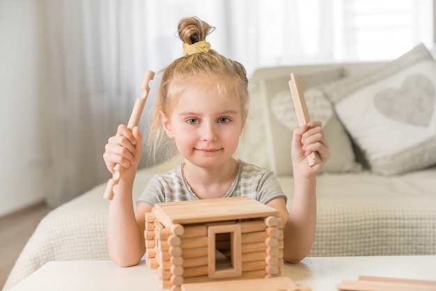 Portrait of little girl with house model.