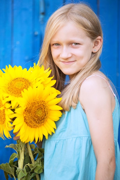 Portrait of a little girl with a sunflower