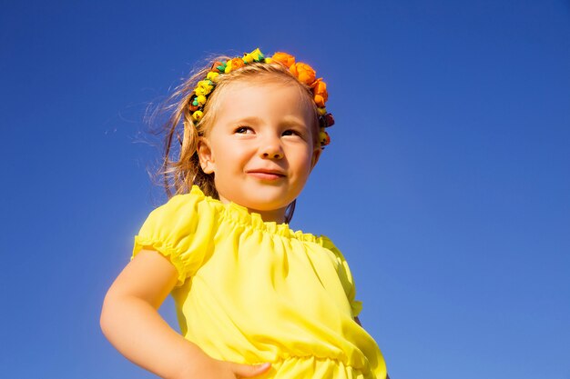 Portrait of a little girl in a yellow dress