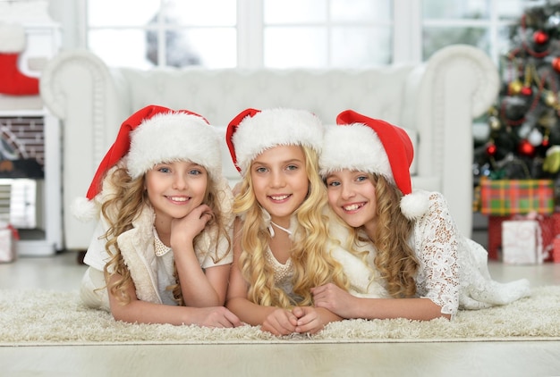 Portrait of little girls in Santa hats