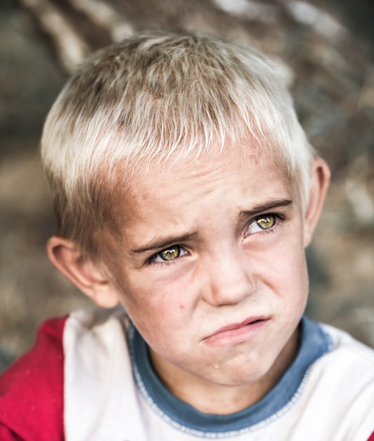 portrait of a little homeless boy