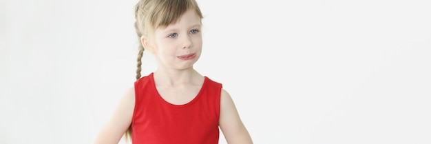 Portrait of little offended girl on white background childish mood and resentment concept