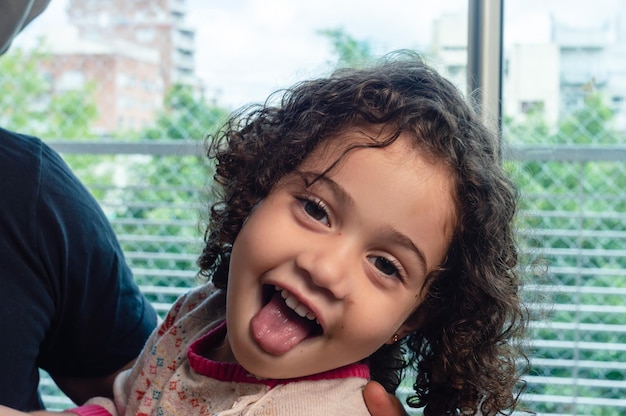 portrait little playful girl looking at the camera