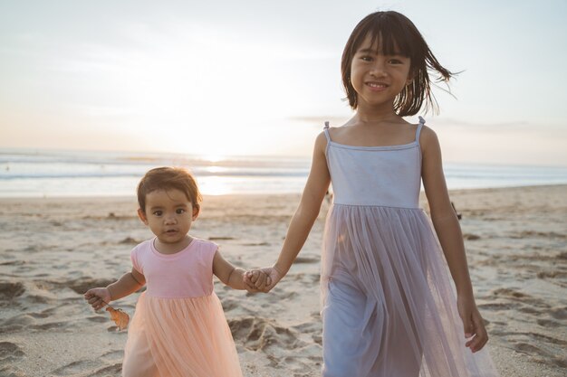 Portrait of little sisters enjoying a vacation on the beach