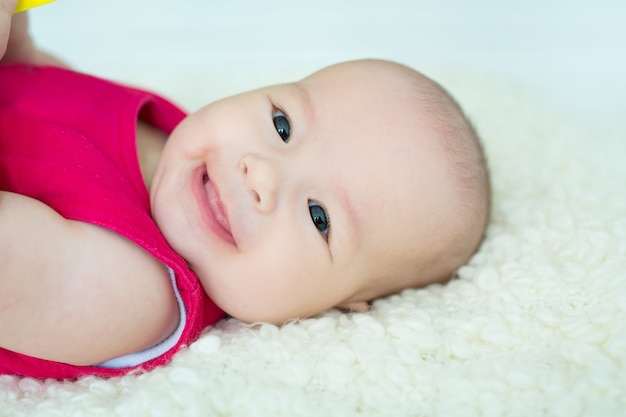 Portrait of a little smiling baby with big brown eyes