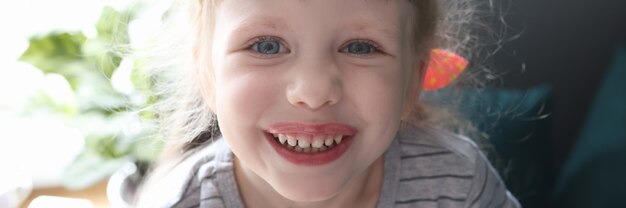 Portrait of little smiling beautiful girl at home