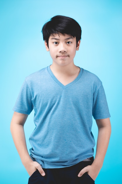 Portrait of look good asian kid on blue.