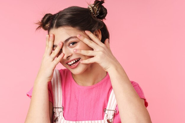 Portrait of lovely charming girl with nose ring posing and smiling at camera isolated over pink wall