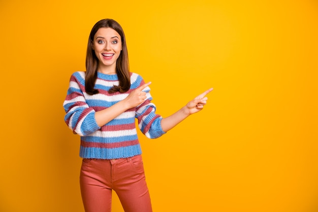 Portrait of lovely cheerful girl showing copy space ad