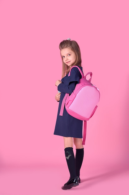 Portrait of lovely confident clever girl with copybook notebook wearing school uniform