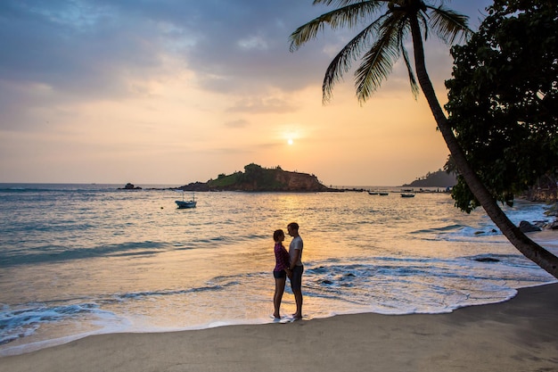 Portrait of lovely couple in love having fun on the beach Young beautiful people hugging Romantic moment Valentine's day Honey moon