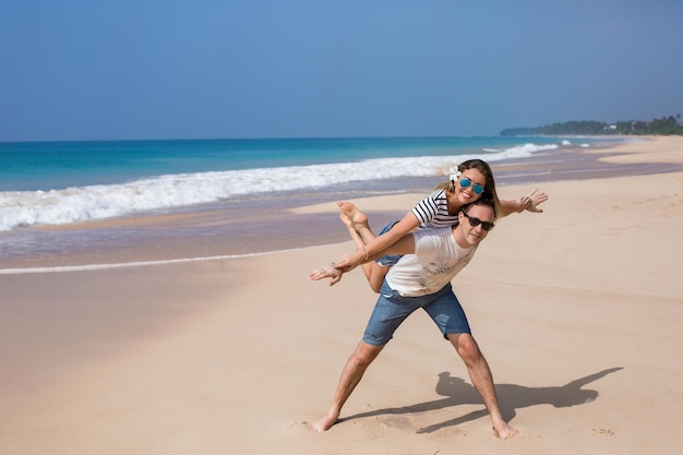 Portrait of lovely couple in love having fun on the beach young\
beautiful people hugging romantic moment valentine\'s day honey\
moon