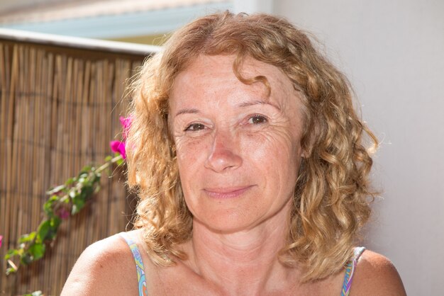 Portrait of lovely middle aged woman smiling at the camera