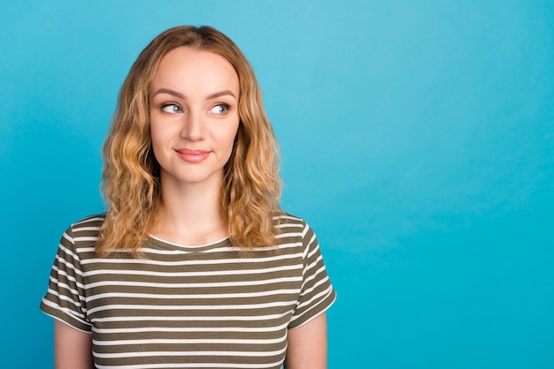 Portrait of lovely nice lady look empty space ads wear casual outfit isolated blue color background