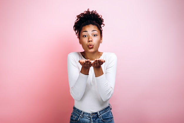 Portrait of a lovely pretty woman sending air kiss