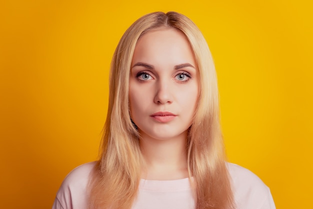 Portrait of lovely sweet pretty calm lady look camera on yellow background