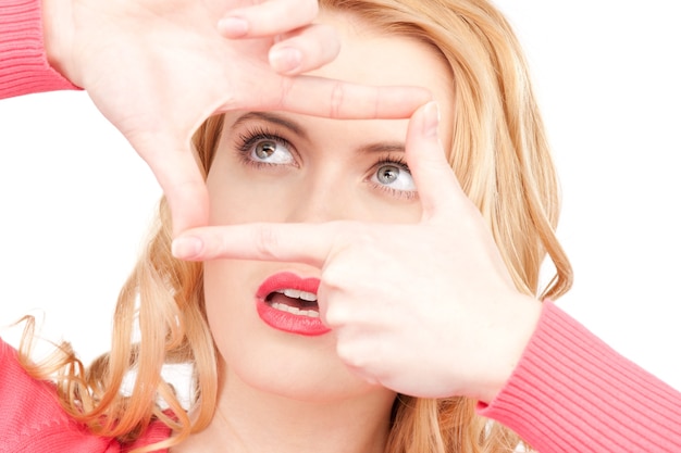 Portrait of lovely woman creating a frame with fingers