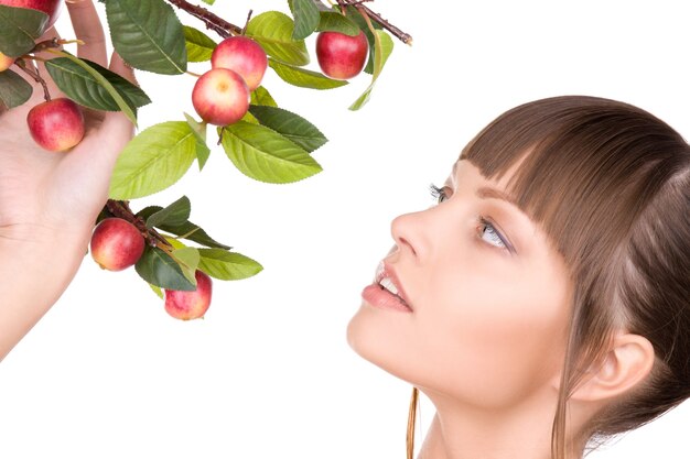 Portrait of lovely woman with apple twig