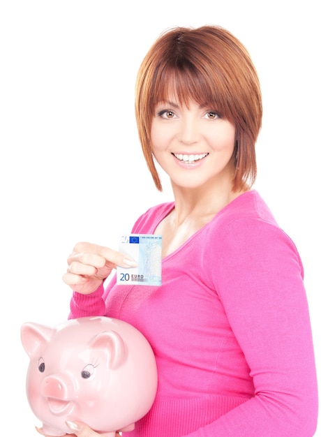 Portrait of lovely woman with piggy bank and money