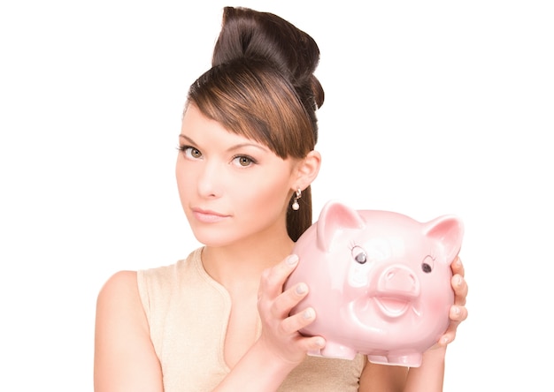 Portrait of lovely woman with piggy bank