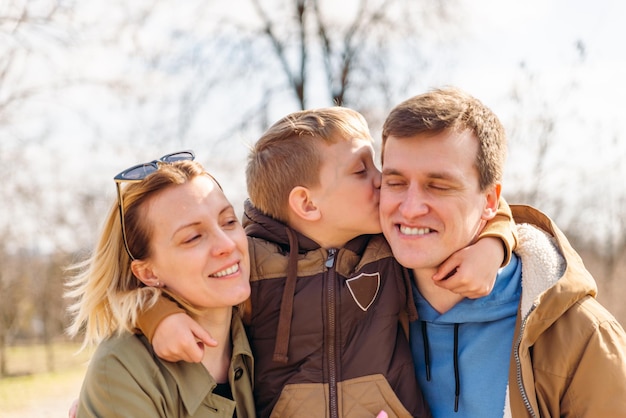 Portrait of lovely young family outdoors