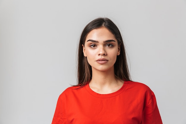 Portrait of a lovely young woman casualy dressed standing isolated on white