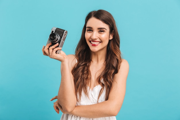 Portrait of a lovely young woman holding photo camera