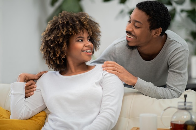 Portrait of loving african american husband and wife at home