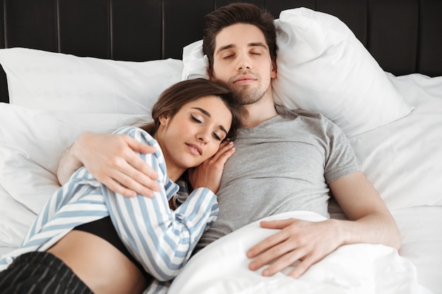 Portrait of a loving young couple sleeping together