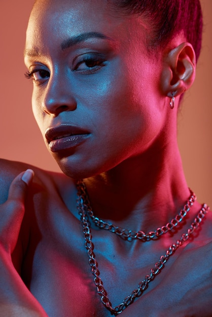 Portrait makeup and closeup with a model black woman in studio on a neon background for beauty Art kaleidoscope and style with an attractive young female posing indoor for culture or cosmetics
