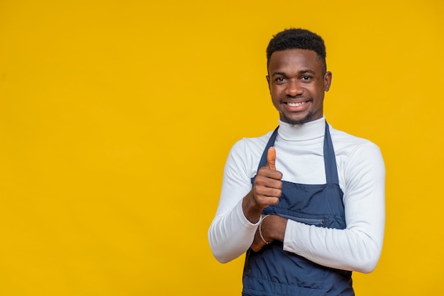 Portrait of a a male african chef smiling and doing a thumbs up gesture