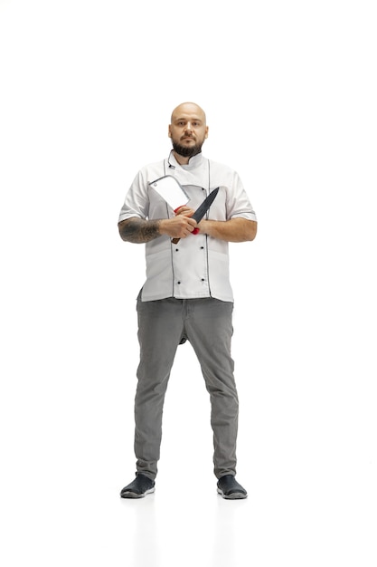 Portrait of a male chef cook, butcher isolated on a white studio background. Concept of professional occupation, work, job, food and restaurant industry. Caucasian man with kitchen utensils.