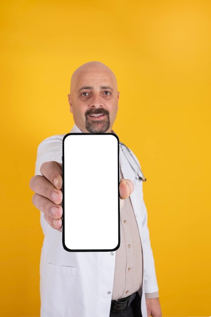 Portrait of male doctor showing empty white screen of smartphone Recommending concept idea