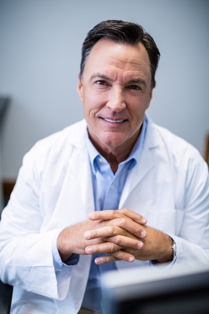 Portrait of male doctor sitting at desk