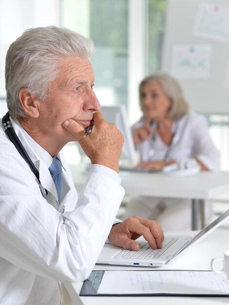 Portrait of male doctor working at desk