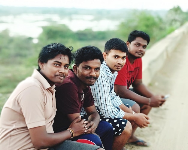 Portrait of male friends sitting