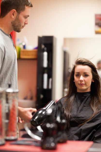 Portrait of a male hairdresser blowing hair