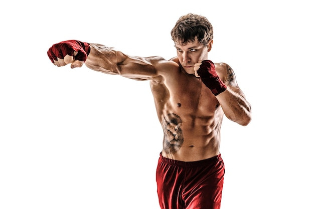 Portrait of male muscular boxer who training and practicing jab on white background red sportswear