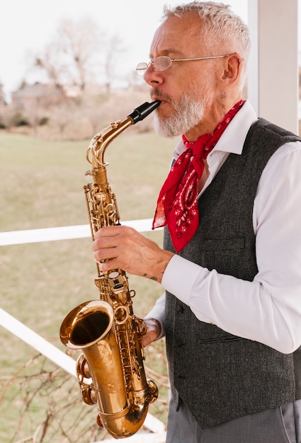 Portrait of male musician playing wind instrument for world music day