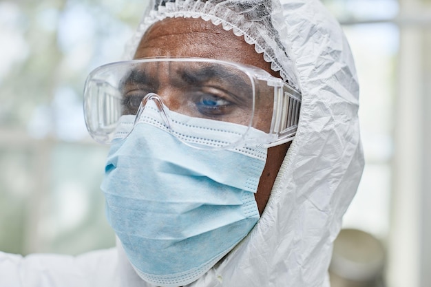 portrait of male production worker in glasses and mask working at pharmaceutical plant